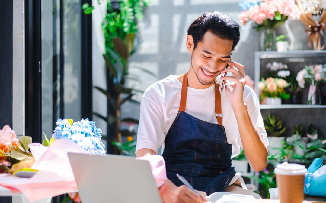 Asian man influencer or SME owner people smile work on home video camera selfie shoot.Smiling female florist talking on mobile phone. Young woman working at shop with Open sign.