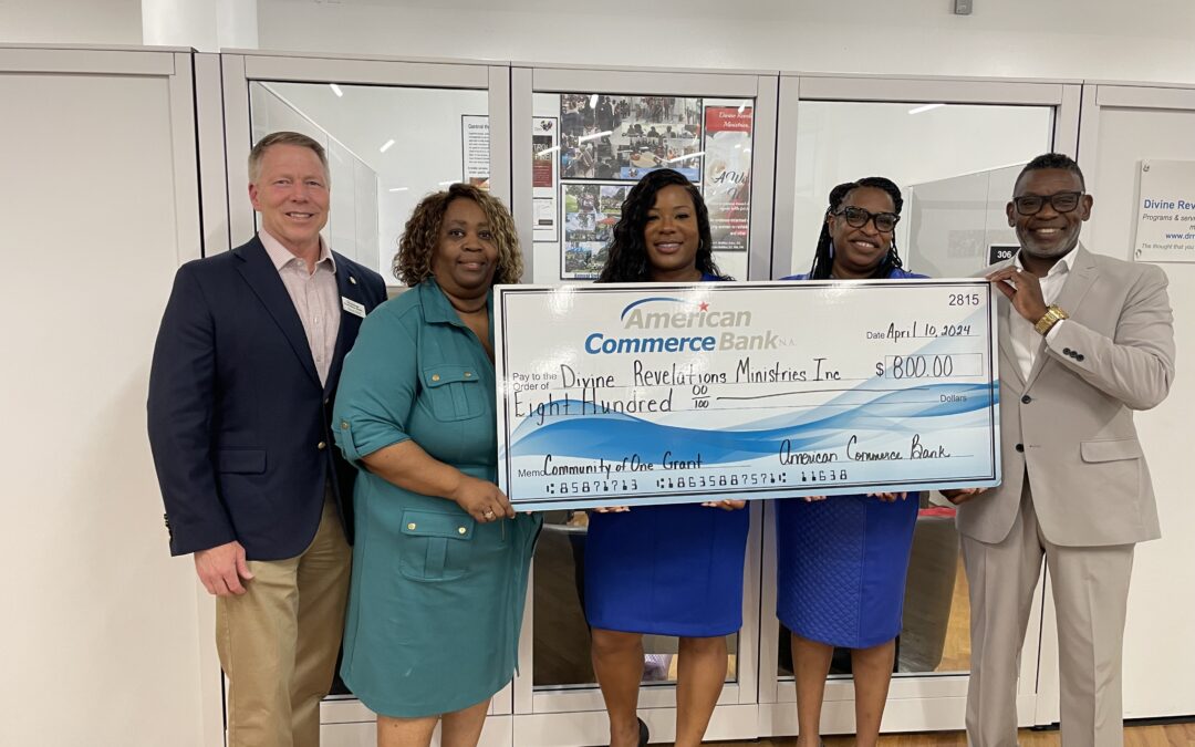 Members from ACB and Divine Ministries pose with donation check